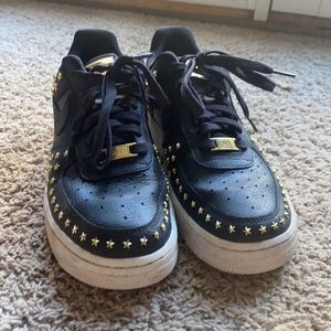 Gold studded air force ones.